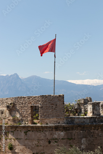 Red waving flag installed on tower