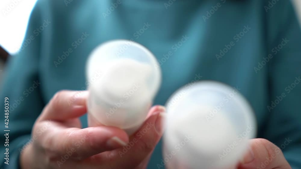 Woman opens a delivered parcel with cosmetics Woman opens a delivered parcel with cosmetics