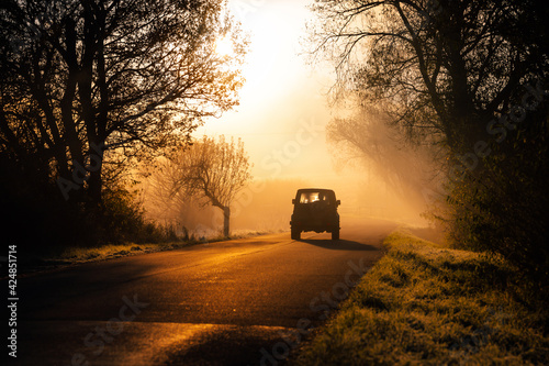 Car silhouette in beautiful orange morning light