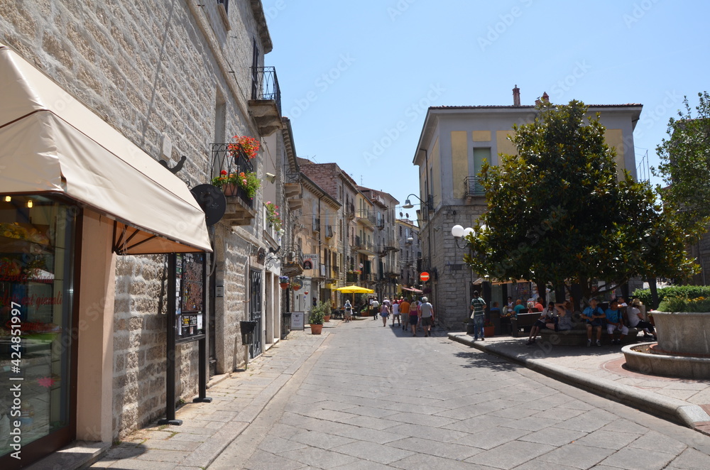 A small street in an old European summer town. The old city in the rays of the summer sun. Walk through the old town. An interesting journey.