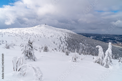 Winter mountain landscape, Poland, Panorama of the Giant Mountains in sunny winter day, from Biała Dolina in Szklarska Poreba on Szrenica and Sniezne Kotly, blue sky, white and dark clouds. Snow cover © Marcin
