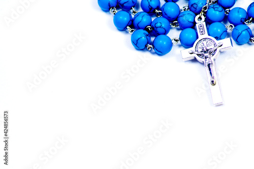 Turquoise rosary on white background for prayer Religious accessory Spiritual Prayer beads Crucifix Cross Christianity Religious icon Resurrection Crucifixion photo