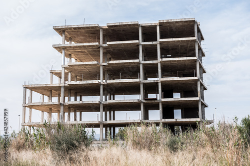 Unfinished residence overall shot. Abandoned project due to the crisis. Concrete foundations remaining. © Julien