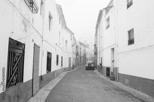 Sierra Engarceran (La Serra d'En Galceran), Valencian Community, Spain. Old spanish village in the fog. Scary atmosphere in an empty street. Monochrome photography (black and white).