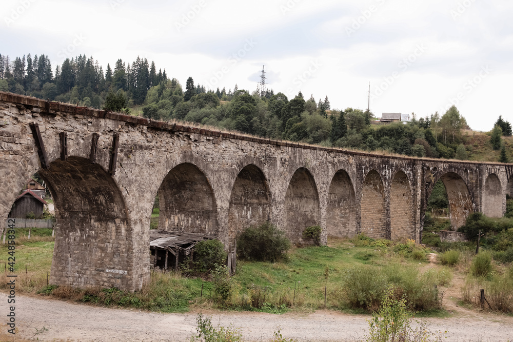 Old railway bridge, old viaduct Vorokhta, Ukraine. Carpathian Mountains, wild mountain landscape