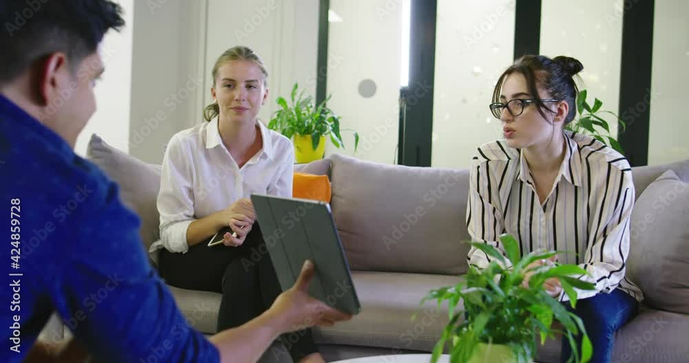 Business people connected on internet network with a tablet in a relax room in startup company Business people connected on internet network with a tablet in a relax room in startup company