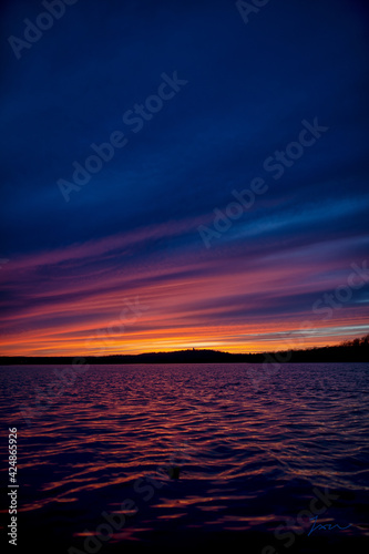 Lake Sunset with dark blues and bright oranges and pink. 