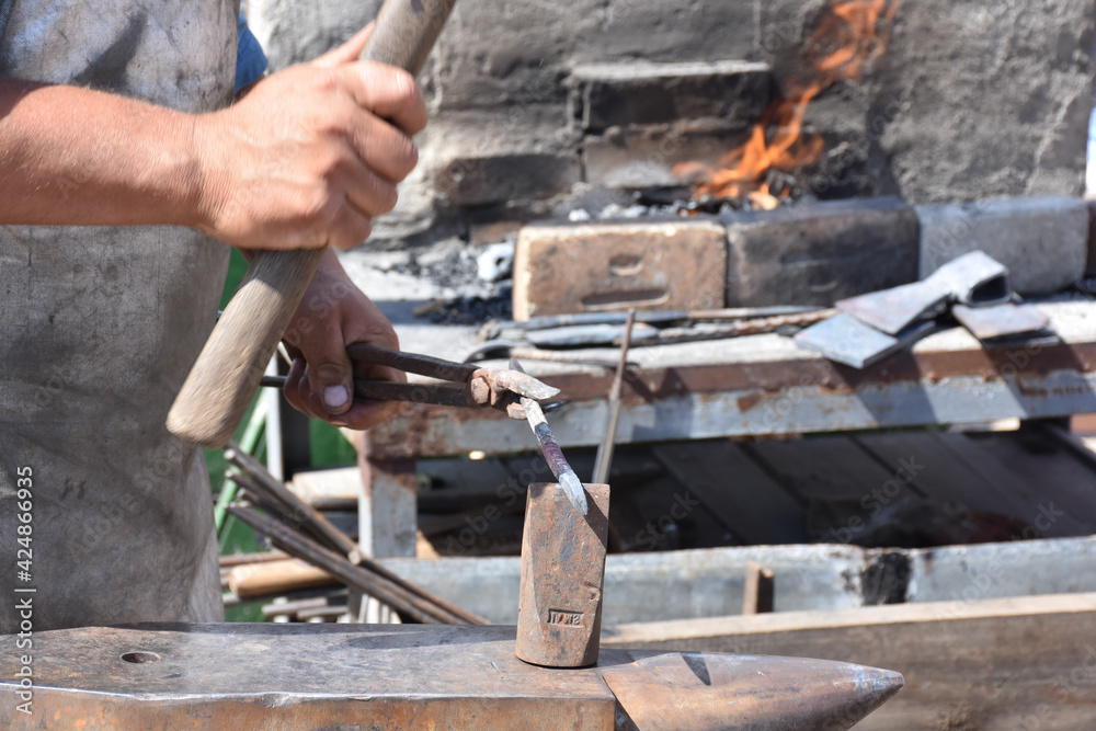 Blacksmith forged ironsmith. traditional hammer beating. Medieval blacksmith. Horseshoe workspace made with the medieval blacksmith method. Blacksmith forged ironsmith. traditional hammer beating. Medieval blacksmith. Horseshoe workspace made with the medieval blacksmith method.