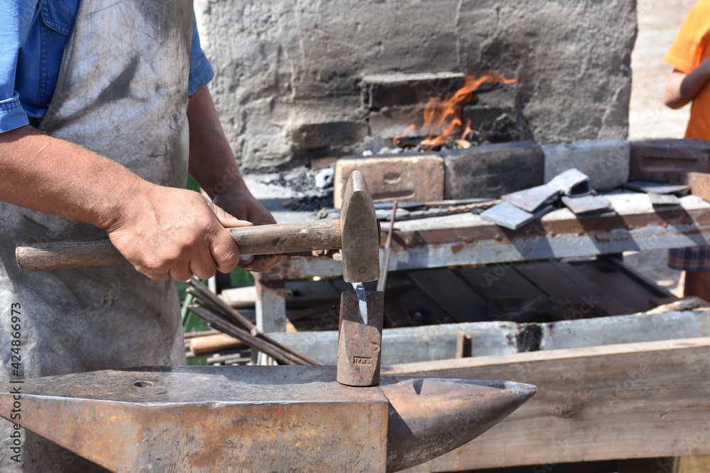 Blacksmith forged ironsmith. traditional hammer beating. Medieval blacksmith. Horseshoe workspace made with the medieval blacksmith method.