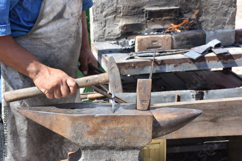 Blacksmith forged ironsmith. traditional hammer beating. Medieval blacksmith. Horseshoe workspace made with the medieval blacksmith method.