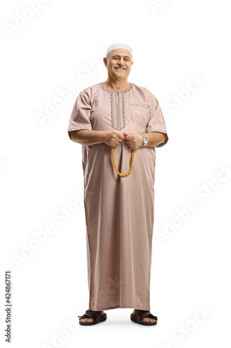Full length portrait of a muslim cleric holding prayer beads