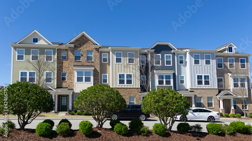 A row of attached residential suburban townhomes