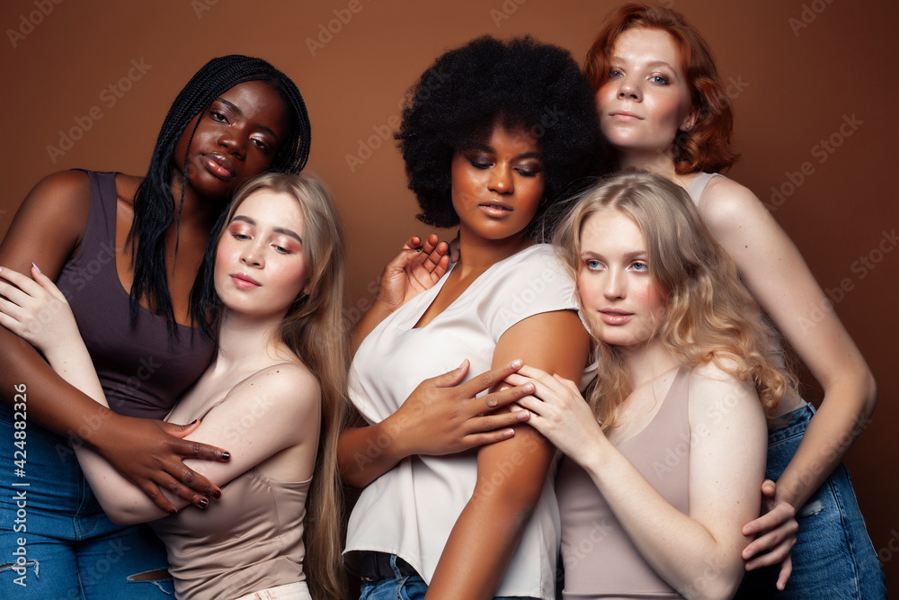 young pretty caucasian, afro, scandinavian woman posing cheerful together on brown background, lifestyle diverse nationality people concept young pretty caucasian, afro, scandinavian woman posing cheerful together on brown background, lifestyle diverse nationality people concept