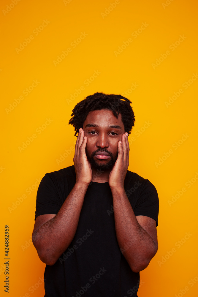 young handsome african american guy student posing cheerful and gesturing on yellow background, lifestyle people concept young handsome african american guy student posing cheerful and gesturing on yellow background, lifestyle people concept