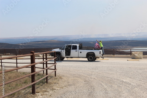 Man setting up the American flag on his truck