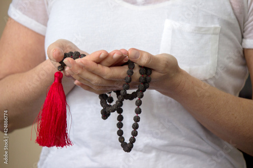 woman reverential with hapa mala sitting for yoga