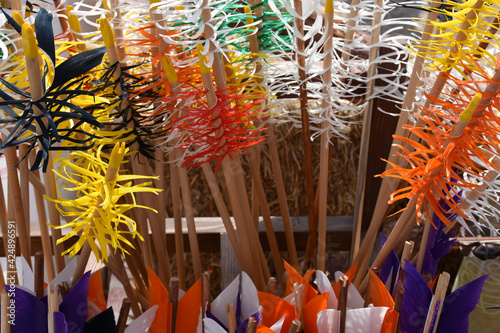 Traditional colorful Wooden Arrows vertically gathered together in a bowl photo