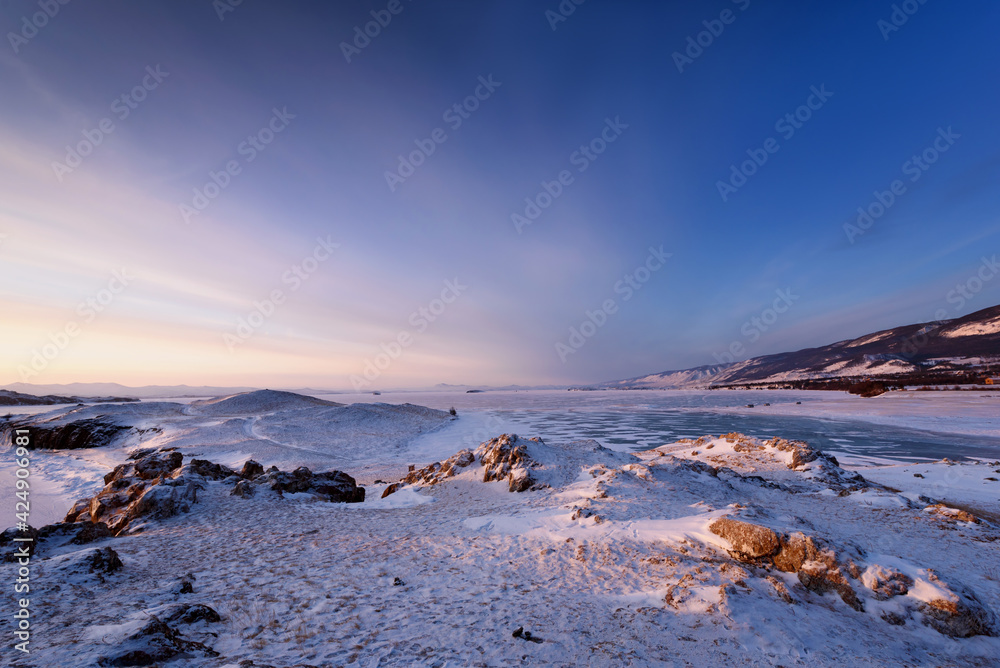 View above big beautiful frozen lake and mountain in winter, Baikal lake, Russia
