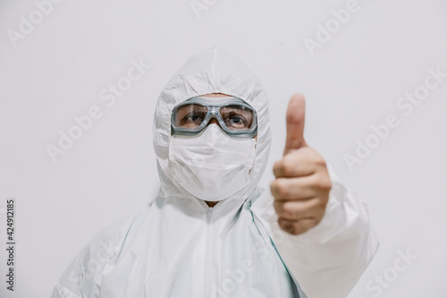 doctor in protective mask showing thumbs up