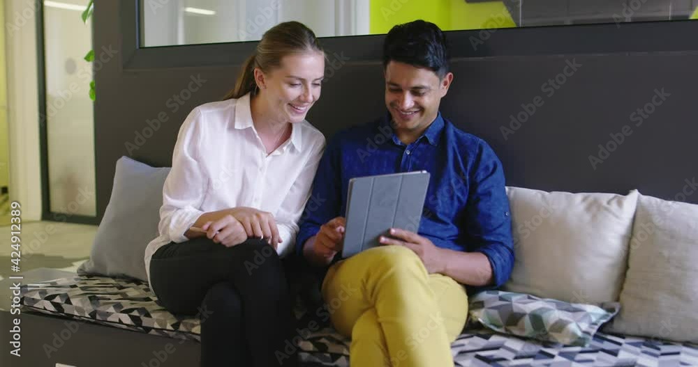 Stratup company with two people using tablet computer at meeting Stratup company with two people using tablet computer at meeting