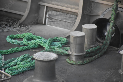 Large ship rope tied to a stake on the ship's deck photo