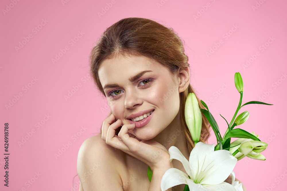 Beautiful woman with flowers on pink background makeup portrait model Beautiful woman with flowers on pink background makeup portrait model
