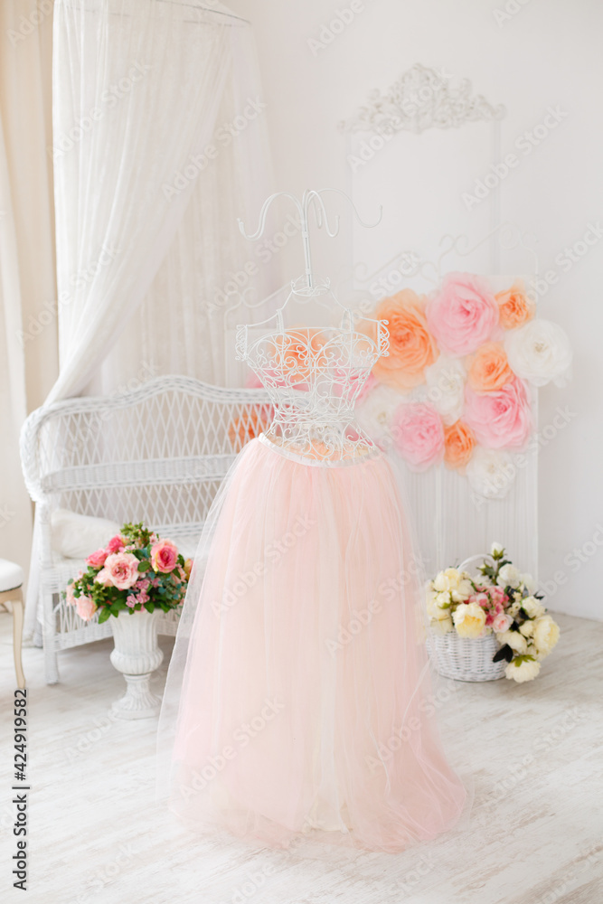 Bridal accessories: wedding dress. Symbol of femininity. delicate tulle skirt on an elegant white curled iron mannequin. Wedding morning Bridal accessories: wedding dress. Symbol of femininity. delicate tulle skirt on an elegant white curled iron mannequin. Wedding morning