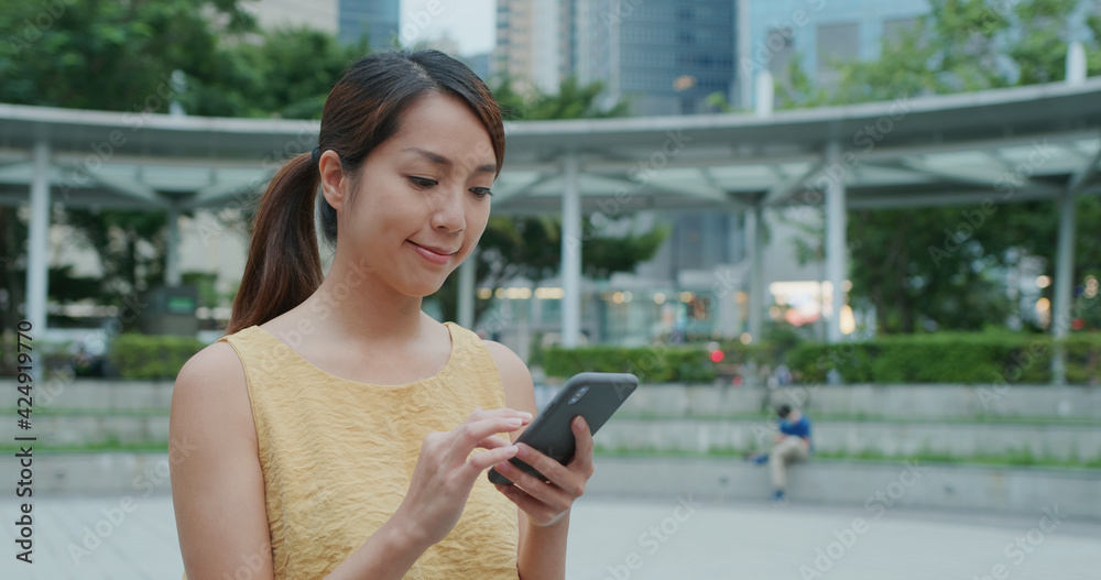 Woman use of mobile phone at outdoor Woman use of mobile phone at outdoor