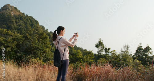 Woman use cellphone to take photo at forest © leungchopan