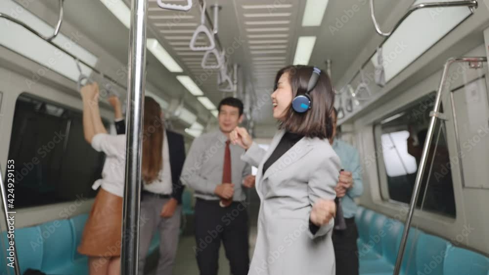 A group of businessmen having fun on the subway after work, The business man dancing happily on the train are on their way home, People of different nationalities Feel relaxed. A group of businessmen having fun on the subway after work, The business man dancing happily on the train are on their way home, People of different nationalities Feel relaxed.