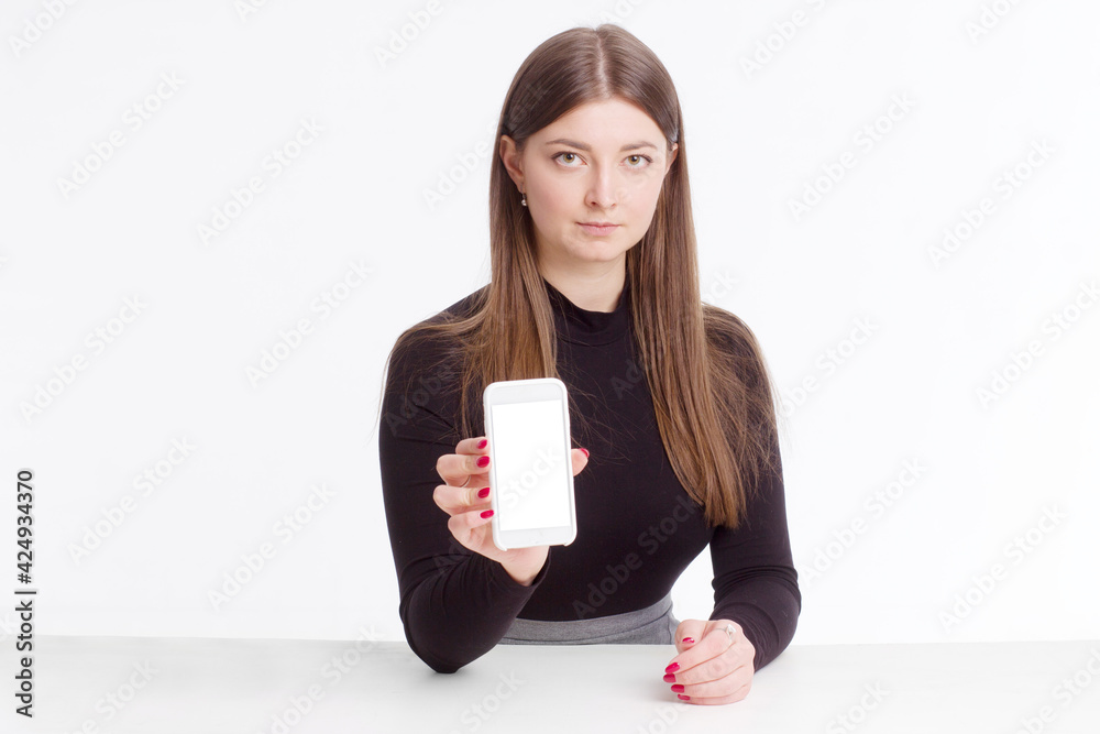 young brunette in a black jumper, sitting on a white isolated background young brunette in a black jumper, sitting on a white isolated background