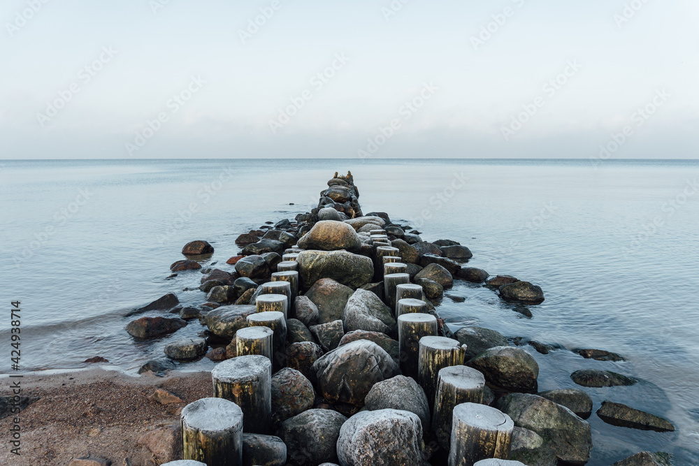 Old wooden breakwater on the background of the Baltic Sea Old wooden breakwater on the background of the Baltic Sea