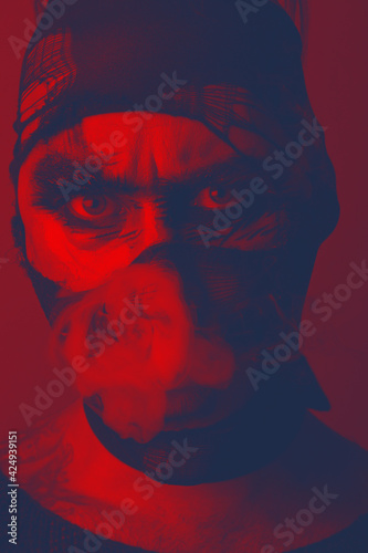 Monochromatic Art portrait of smoking man in mask. Creative makeup fashion art design.