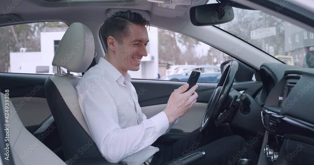 Surprised excited business man winner hold smartphone read good news amazed by mobile online bet bid game win while sitting in a car. Surprised excited business man winner hold smartphone read good news amazed by mobile online bet bid game win while sitting in a car.
