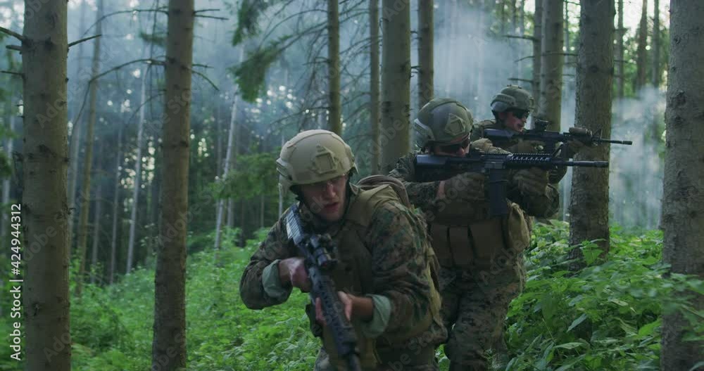Millitary operation with gorup of soliders attacking enemy line in dense forest during day time