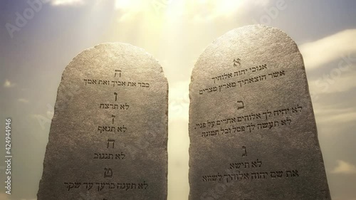 Golden letters of the Ten Commandments on the stone tablets. God told Moses about the Ten Commandments on the stone tablets. Excerpted from the Bible, Exodus 20:1-17, 3D rendered animation. photo