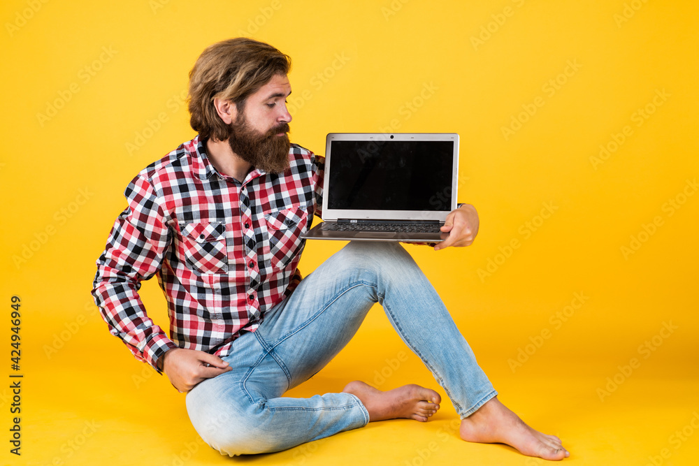 brutal bearded man wear checkered shirt having lush beard and moustache working on laptop, new technology brutal bearded man wear checkered shirt having lush beard and moustache working on laptop, new technology
