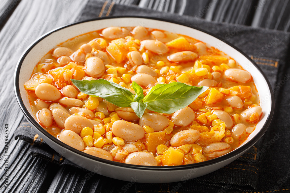 Vegetarian Porotos granados bean stew with corn, pumpkin and onions close-up in a bowl on the table. horizontal Vegetarian Porotos granados bean stew with corn, pumpkin and onions close-up in a bowl on the table. horizontal