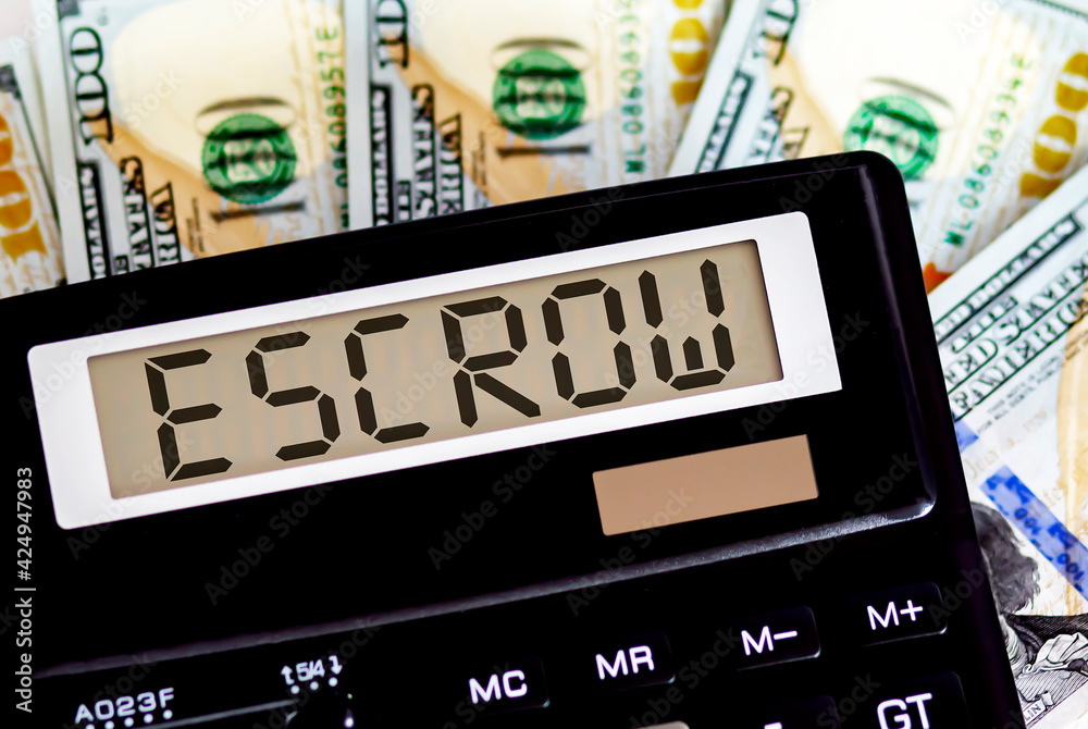 Calculator with text ESCROW on the dollars. Business, finance conceptual. Calculator with text ESCROW on the dollars. Business, finance conceptual.
