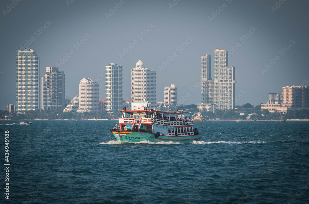 Tour boat sailing out of Pattaya Bay, Thailand