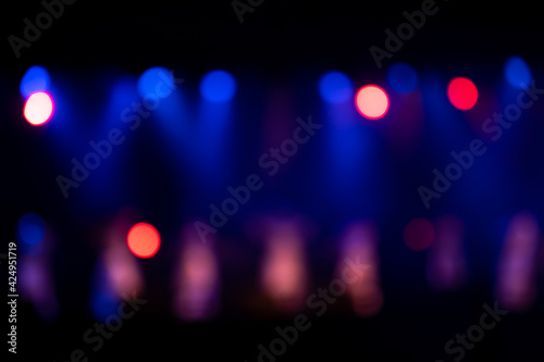 Defocused entertainment concert lighting on stage. Blue Stage Lights. Colorful bright stage lights in concert. Bokeh Banner background.