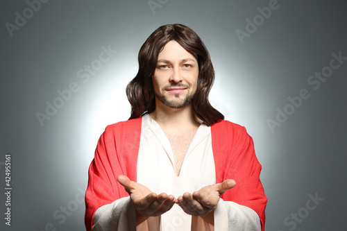 Canvas Print Jesus Christ reaching out his hands on grey background