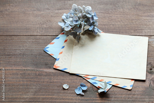 Vintage envelopes and dried hortensia flowers on the table. Love leters from the past.