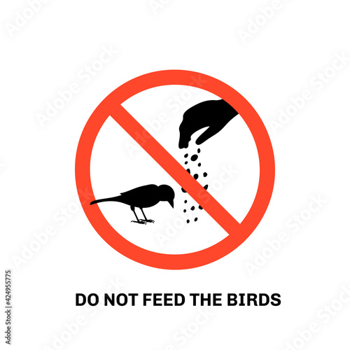 Prohibition sign with text do not feed the birds and hand silhouette giving food to sparrow. Isolated on white background. Stock vector illustration.