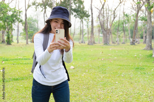 Young woman taking picture of a park in the university. photo