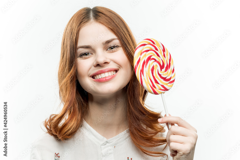 cute red-haired woman round lollipop delight glamor cropped view