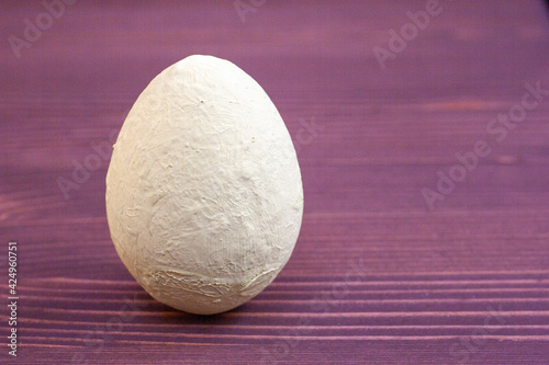 Hand-painted decorative light milky eggon a red wooden background.Happy easter concept photo