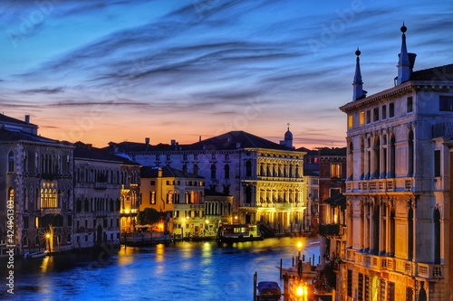 Amazing colorful sunset at the grande canal and beautiful illuminated buildings in Venice Italy