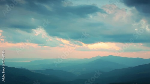 Sunset and Clouds Over the Silhouettes of the Mountains. Fast Motion