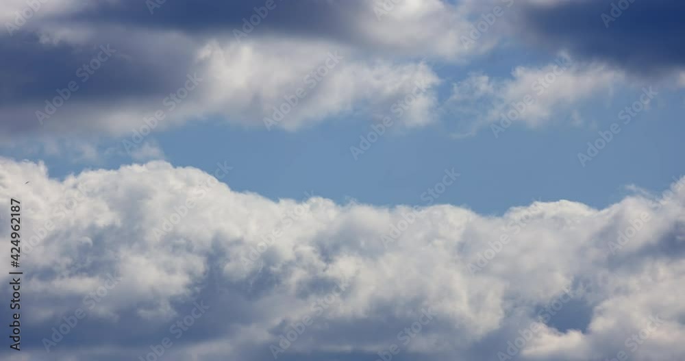 Flying through beautiful thick fluffy clouds. Amazing timelapse of soft white clouds moving slowly on the clear blue sky in pure daylight Flying through beautiful thick fluffy clouds. Amazing timelapse of soft white clouds moving slowly on the clear blue sky in pure daylight
